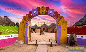 VIBRANT VILLAGE ENTRANCE ARCH WITH COLORFUL MUD HOUSES AND PINK SKY - PRINTED BACKDROP