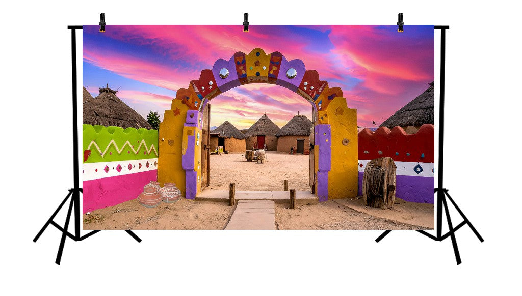 VIBRANT VILLAGE ENTRANCE ARCH WITH COLORFUL MUD HOUSES AND PINK SKY - PRINTED BACKDROP